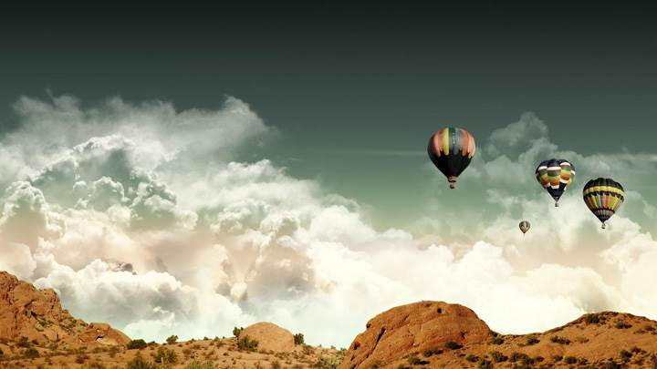 Ballon Flying Over A Valley